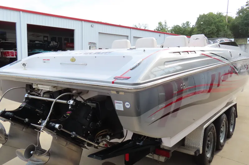 Slide: The Image of 2007 Donzi 35 ZR speedboat with dual engines on a trailer, parked outside a garage. - 6