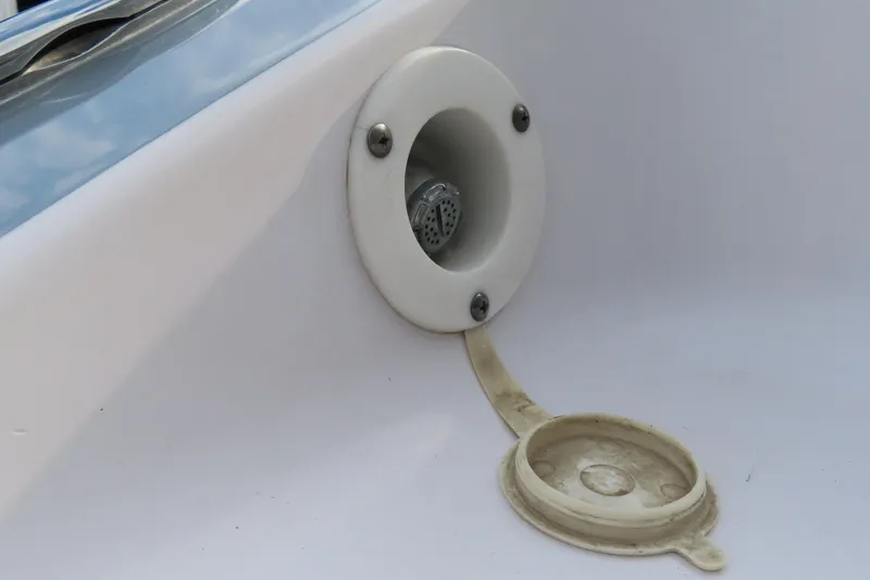 Slide: The Image of Fuel cap of a 2007 Donzi 35 ZR boat, featuring a white cover and screws. - 9
