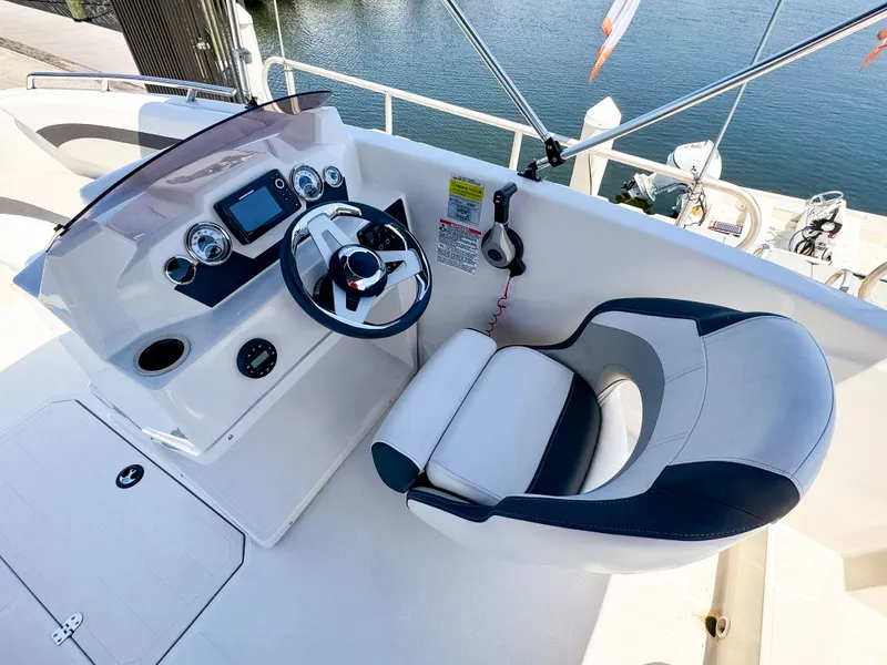 Slide: The Image of 2023 Starcraft SVX 171 OB boat helm with steering wheel and comfortable captain's chair. - 12