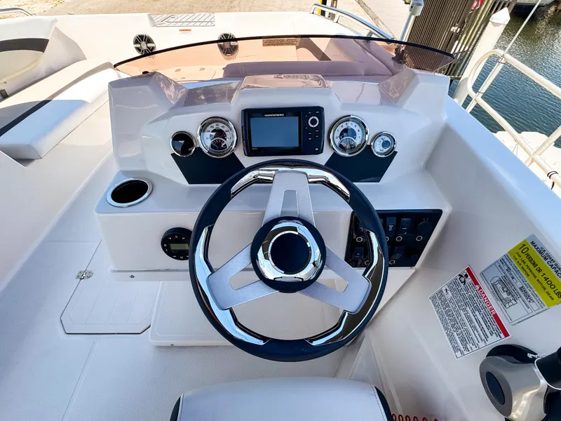 Slide: The Image of 2023 Starcraft SVX 171 OB boat dashboard with steering wheel and gauges. - 15