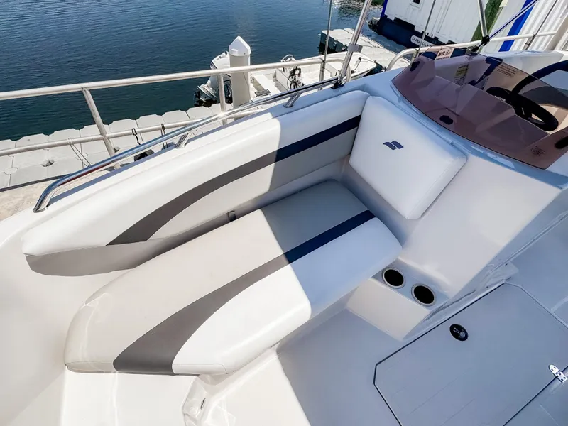 Slide: The Image of 2023 Starcraft SVX 171 OB boat interior with cushioned seating and cup holders. - 19