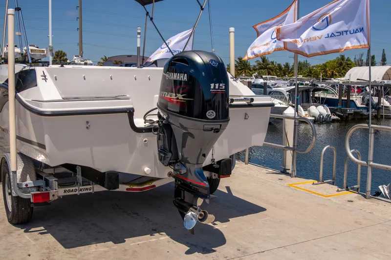 Slide: The Image of 2023 Starcraft SVX 171 OB boat with Yamaha 115 engine at marina dock. - 2
