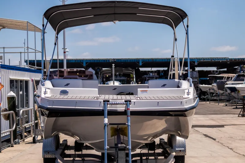 Slide: The Image of 2023 Starcraft SVX 171 OB boat on trailer, marina background, sunny day. - 6