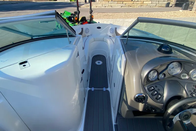 Slide: The Image of 2008 Rinker 246 Captiva Bowrider interior with dashboard and seating area. - 10
