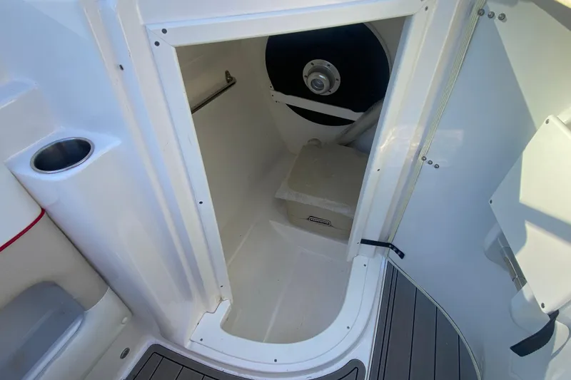 Slide: The Image of 2008 Rinker 246 Captiva Bowrider interior storage compartment with cup holder. - 11