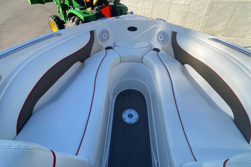 Slide: The Image of 2008 Rinker 246 Captiva Bowrider interior with white seating and red accents. - 13