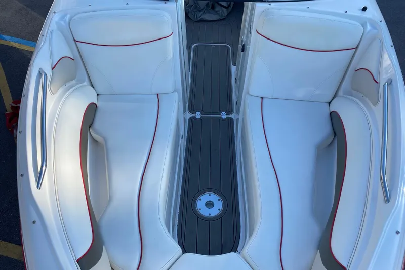 Slide: The Image of 2008 Rinker 246 Captiva Bowrider interior with white seating and red accents. - 14