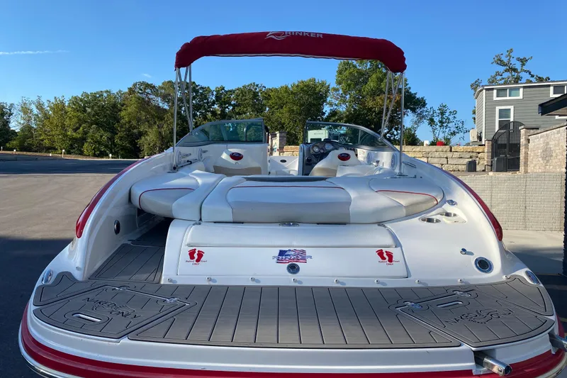 Slide: The Image of 2008 Rinker 246 Captiva Bowrider with red canopy, parked on a sunny day. - 3