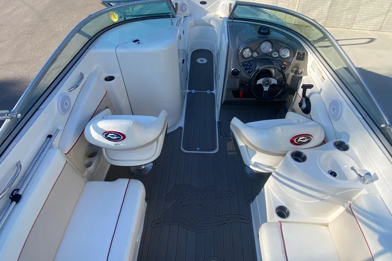 Slide: The Image of 2008 Rinker 246 Captiva Bowrider interior with white seating and modern dashboard. - 5