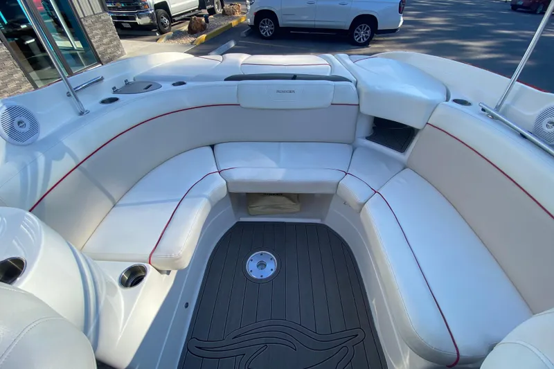 Slide: The Image of 2008 Rinker 246 Captiva Bowrider interior with white seating and red accents. - 6