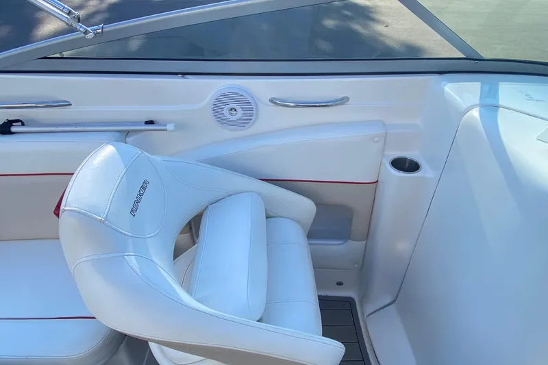 Slide: The Image of 2008 Rinker 246 Captiva Bowrider interior with white seating and cup holder. - 7