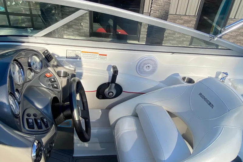 Slide: The Image of 2008 Rinker 246 Captiva Bowrider cockpit with steering wheel and control panel. - 8