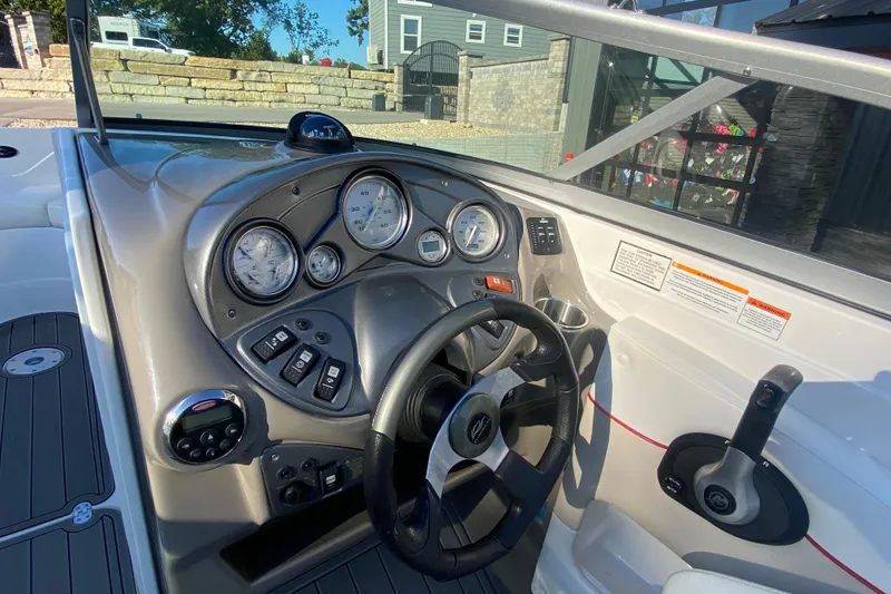 Slide: The Image of 2008 Rinker 246 Captiva Bowrider dashboard with steering wheel and gauges. - 9