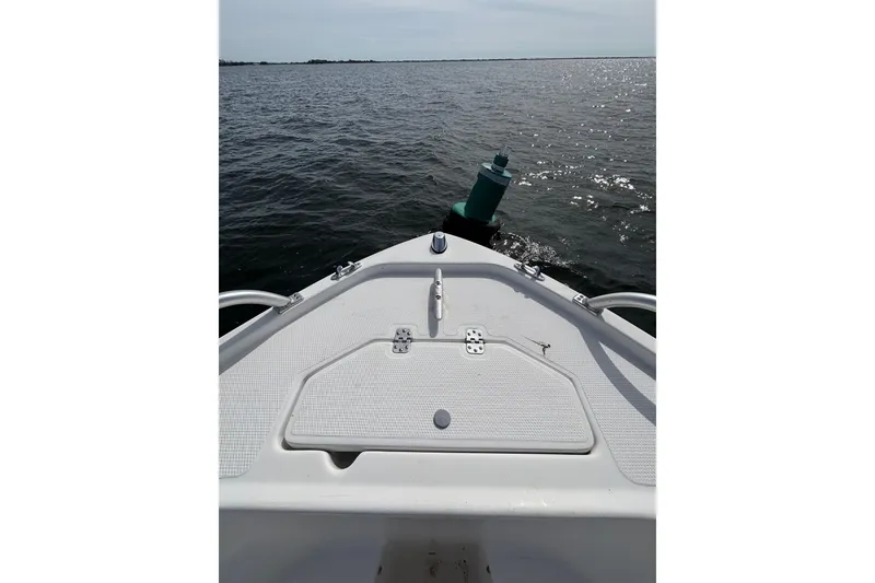 Slide: The Image of Bow view of 2008 Mako 212 Center Console boat on open water. - 10