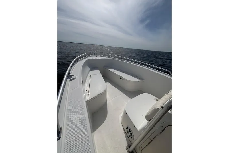 Slide: The Image of 2008 Mako 212 Center Console boat on open water, featuring spacious seating and sleek design. - 11