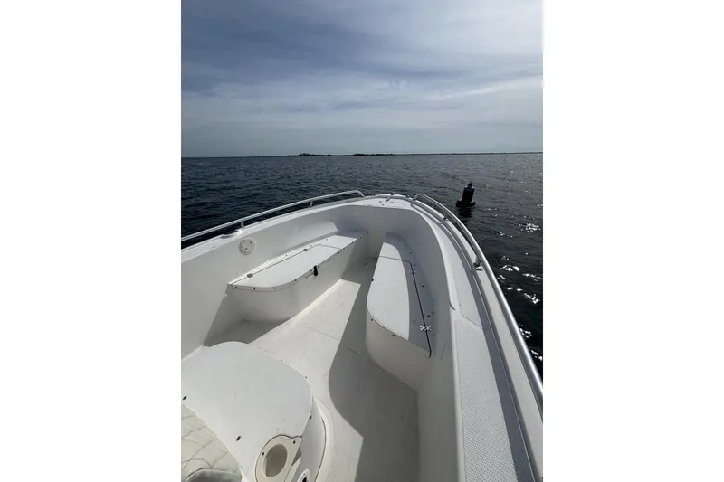 Slide: The Image of 2008 Mako 212 Center Console boat on calm ocean waters. - 12