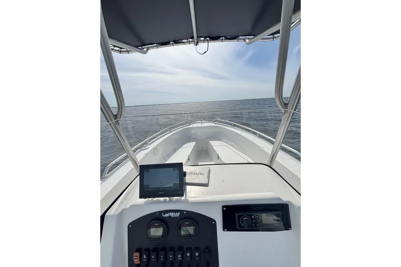 Slide: The Image of 2008 Mako 212 Center Console boat dashboard with ocean view under clear sky. - 15
