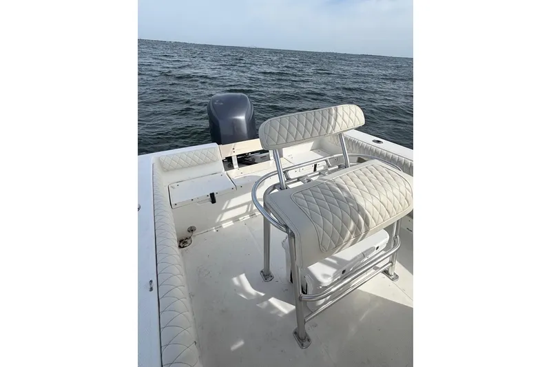 Slide: The Image of 2008 Mako 212 Center Console boat with cushioned seating, on open water. - 21