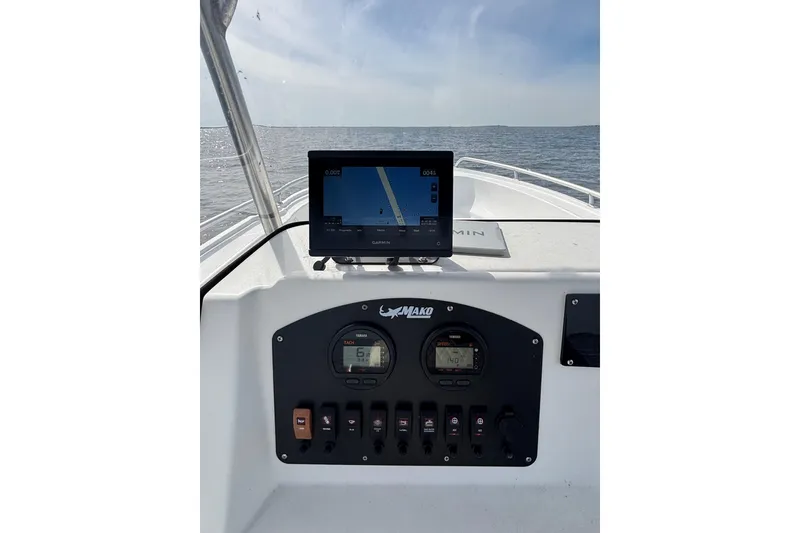 Slide: The Image of 2008 Mako 212 Center Console boat dashboard with Garmin navigation system on open water. - 22