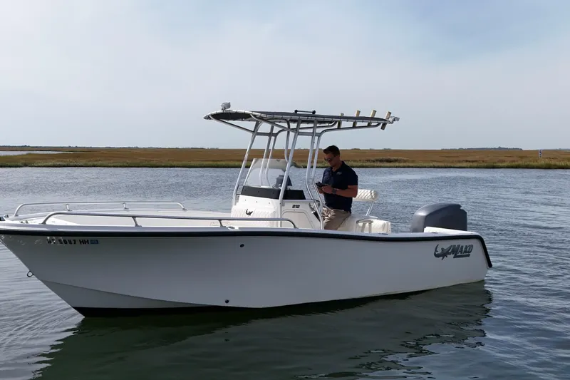 Slide: The Image of 2008 Mako 212 Center Console boat on calm water with a person onboard. - 6