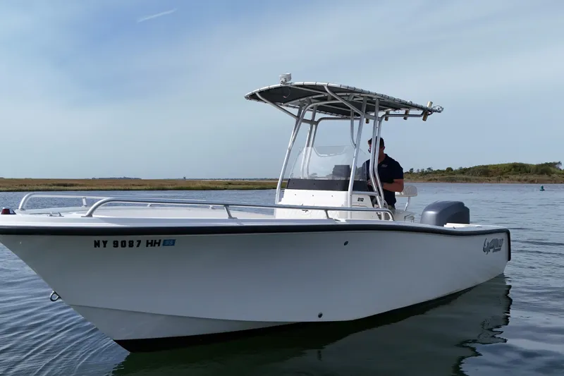 Slide: The Image of 2008 Mako 212 Center Console boat on calm water, side view. - 7