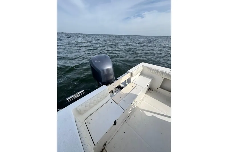 Slide: The Image of 2008 Mako 212 Center Console boat on open water, featuring a powerful outboard motor. - 9