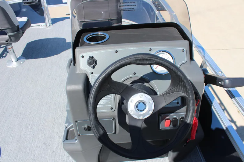Slide: The Image of 2026 Sun Tracker Bass Buggy 16 XL Select steering console with cup holder and controls. - 12