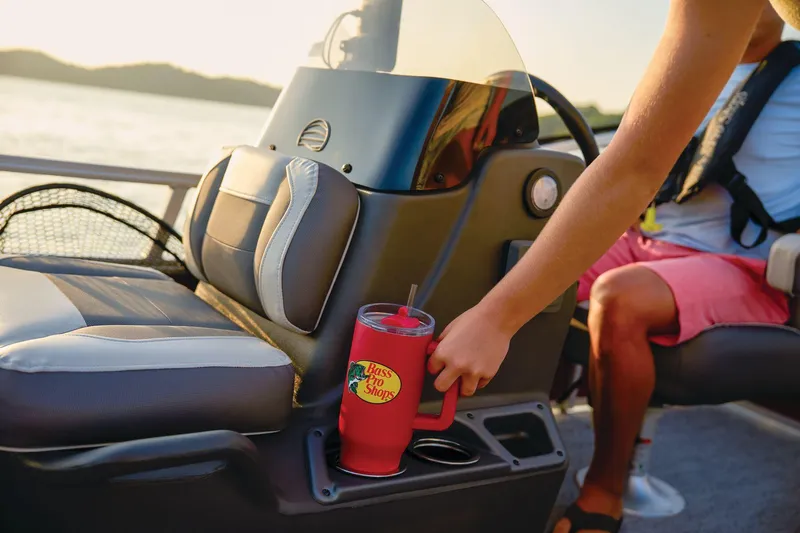 Slide: The Image of Manufacturer Provided Image: Person placing a red cup in a holder on a 2026 Sun Tracker Bass Buggy 16 XL Select boat. - 80