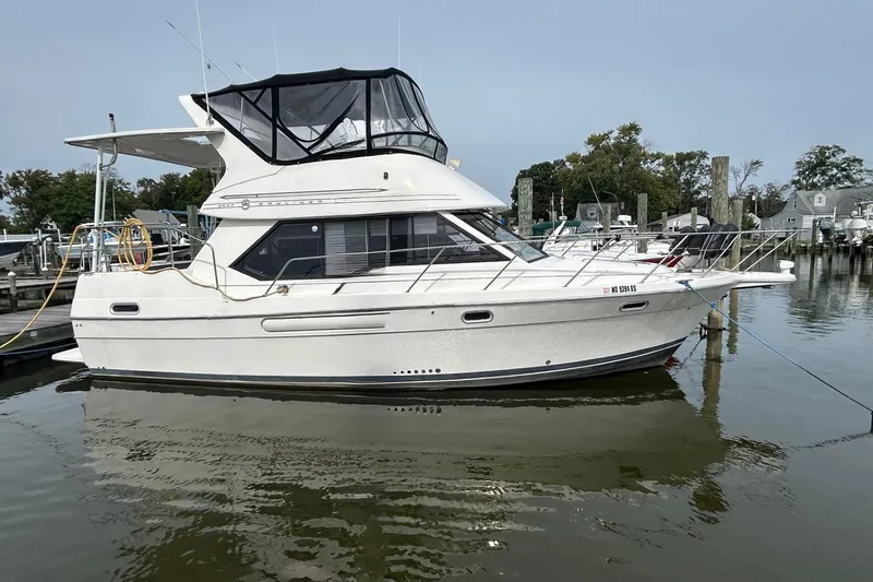 Slide: The Image of 1997 Bayliner 3587 Motoryacht docked at marina, side view. - 0