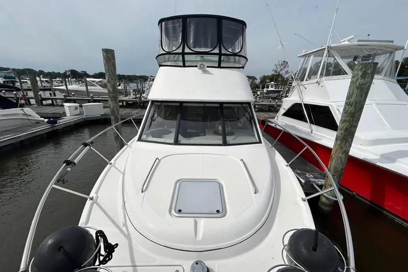 Slide: The Image of 1997 Bayliner 3587 Motoryacht docked at marina, front view. - 10