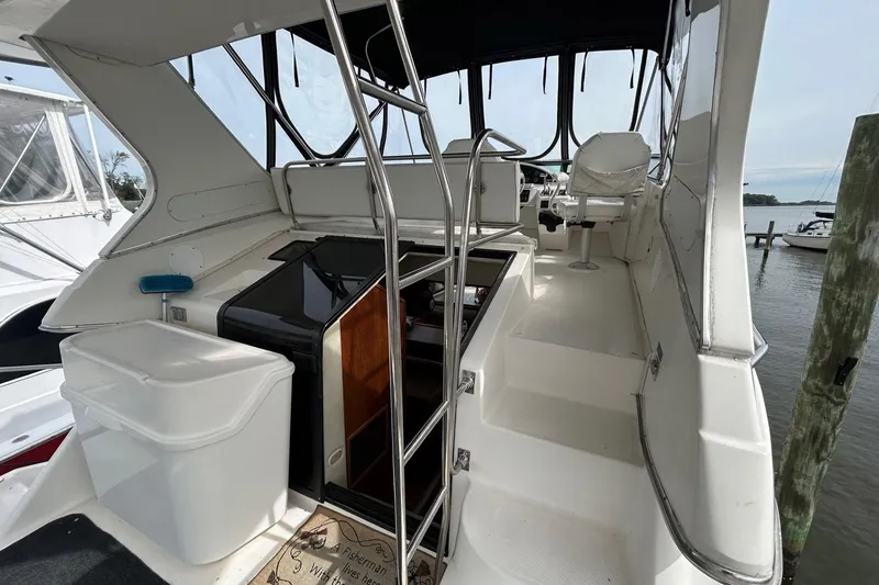 Slide: The Image of 1997 Bayliner 3587 Motoryacht interior with helm, seating, and storage, docked at marina. - 13