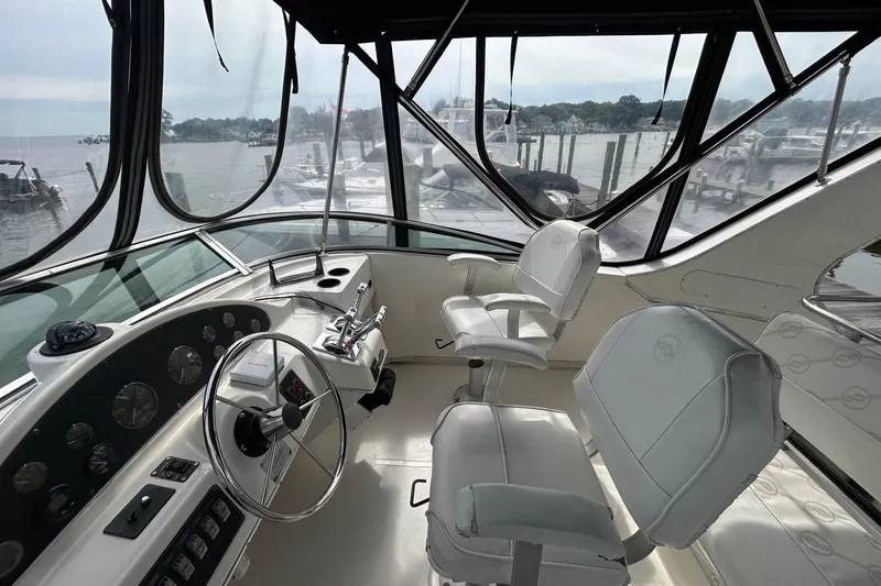 Slide: The Image of 1997 Bayliner 3587 Motoryacht helm with dual captain chairs and panoramic windows. - 16