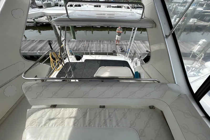 Slide: The Image of 1997 Bayliner 3587 Motoryacht interior view with seating and dockside perspective. - 17