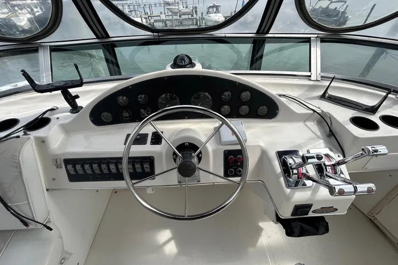 Slide: The Image of 1997 Bayliner 3587 Motoryacht helm with steering wheel and control panel. - 18