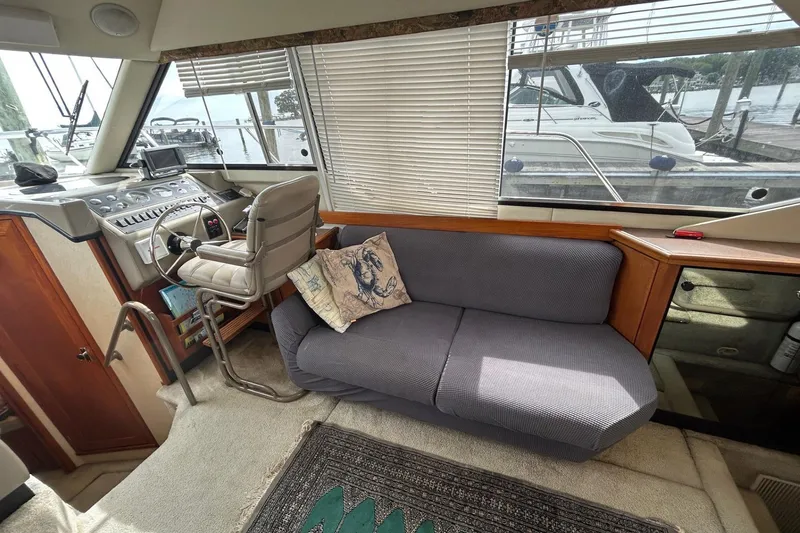 Slide: The Image of 1997 Bayliner 3587 Motoryacht interior with helm, seating, and marina view. - 20