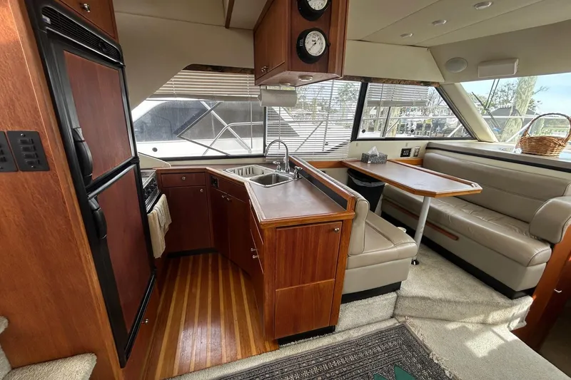 Slide: The Image of Interior of 1997 Bayliner 3587 Motoryacht with kitchen and dining area. - 21