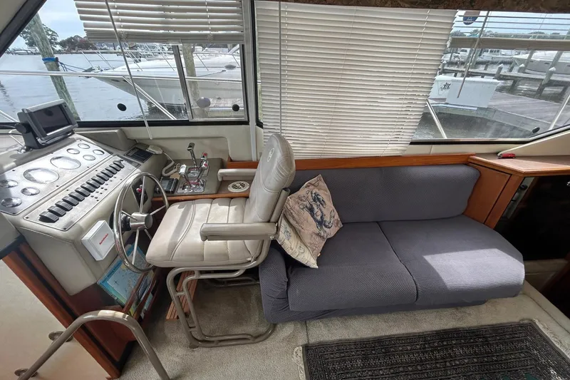 Slide: The Image of 1997 Bayliner 3587 Motoryacht interior with helm, steering wheel, and comfortable seating. - 24