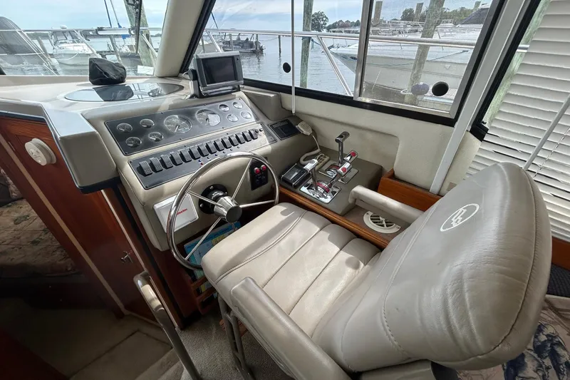 Slide: The Image of 1997 Bayliner 3587 Motoryacht helm with steering wheel, controls, and navigation equipment. - 25