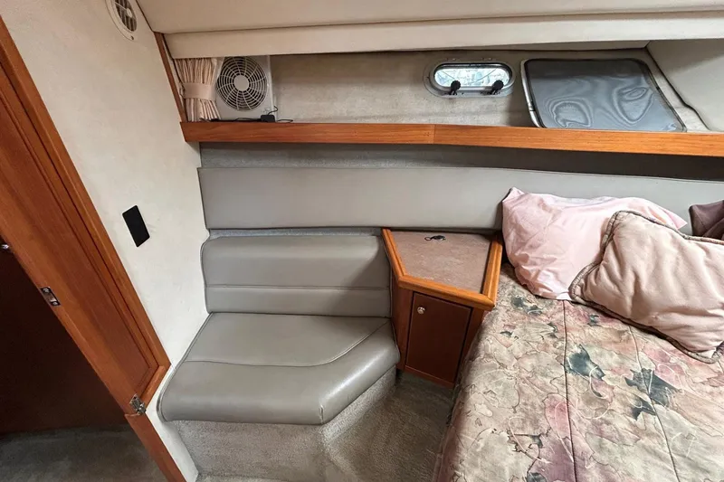 Slide: The Image of 1997 Bayliner 3587 Motoryacht interior with seating, bed, and small fan. - 28
