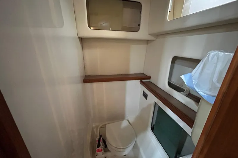 Slide: The Image of 1997 Bayliner 3587 Motoryacht bathroom with toilet and storage shelves. - 34
