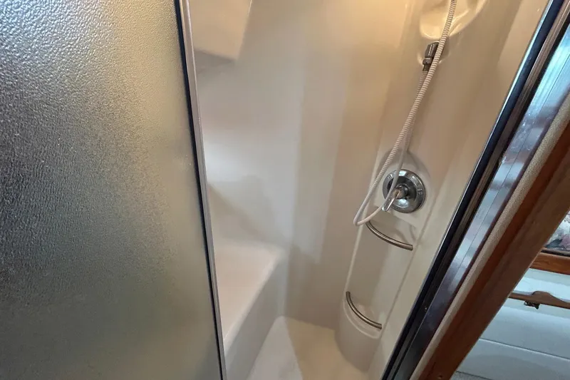 Slide: The Image of Shower area in 1997 Bayliner 3587 Motoryacht with modern fixtures and frosted glass door. - 35