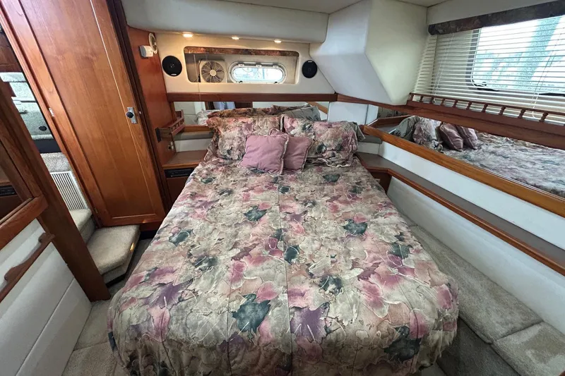 Slide: The Image of Cozy bedroom in 1997 Bayliner 3587 Motoryacht with floral bedding and wood accents. - 37