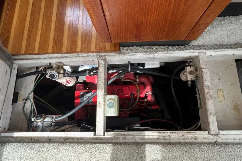 Slide: The Image of Engine compartment of a 1997 Bayliner 3587 Motoryacht with visible red engine components. - 39