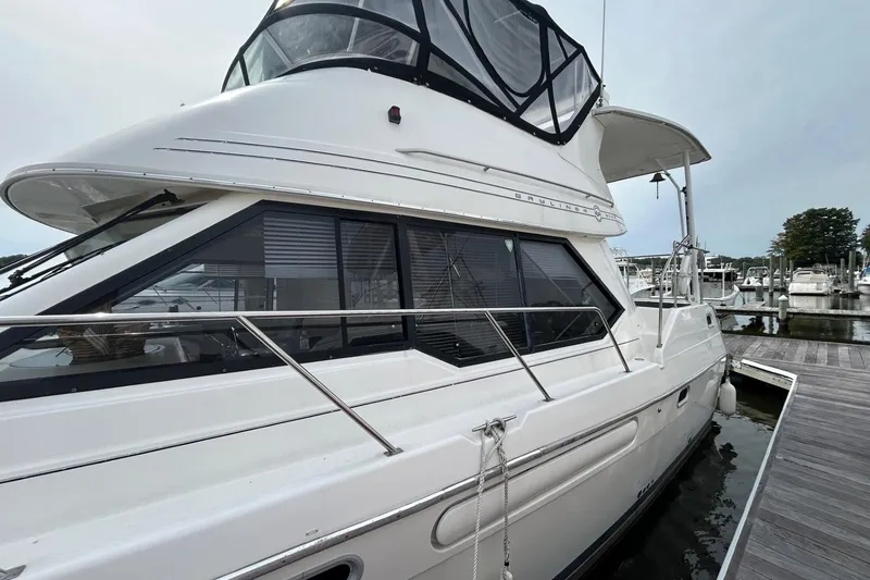 Slide: The Image of 1997 Bayliner 3587 Motoryacht docked at marina, showcasing sleek design and spacious cabin. - 4