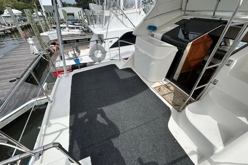 Slide: The Image of 1997 Bayliner 3587 Motoryacht deck with carpet, docked at marina. - 5