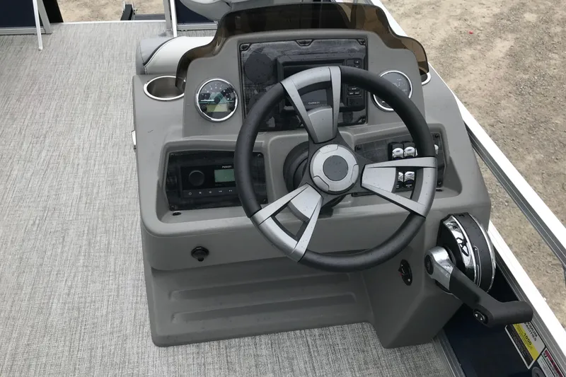 Slide: The Image of Steering console of 2026 Avalon 19 Venture Quad Fish boat, featuring modern controls and gauges. - 12