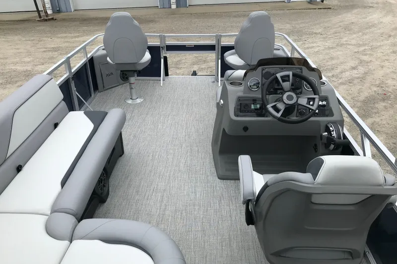 Slide: The Image of 2026 Avalon 19 Venture Quad Fish pontoon boat interior with modern seating and steering console. - 13