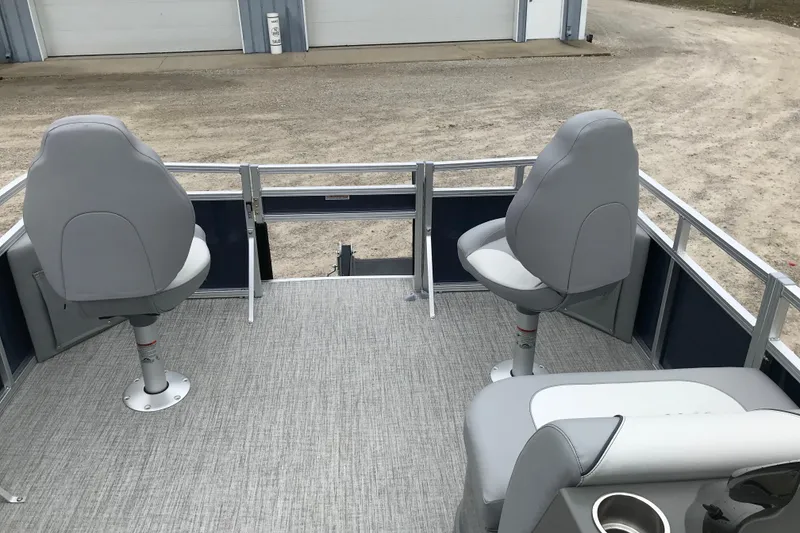 Slide: The Image of 2026 Avalon 19 Venture Quad Fish boat with gray seating and carpeted deck. - 14