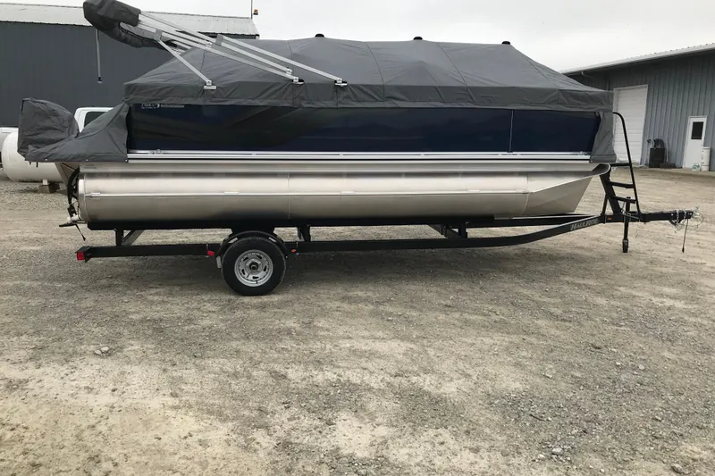 Slide: The Image of 2026 Avalon 19 Venture Quad Fish pontoon boat with cover on trailer. - 29