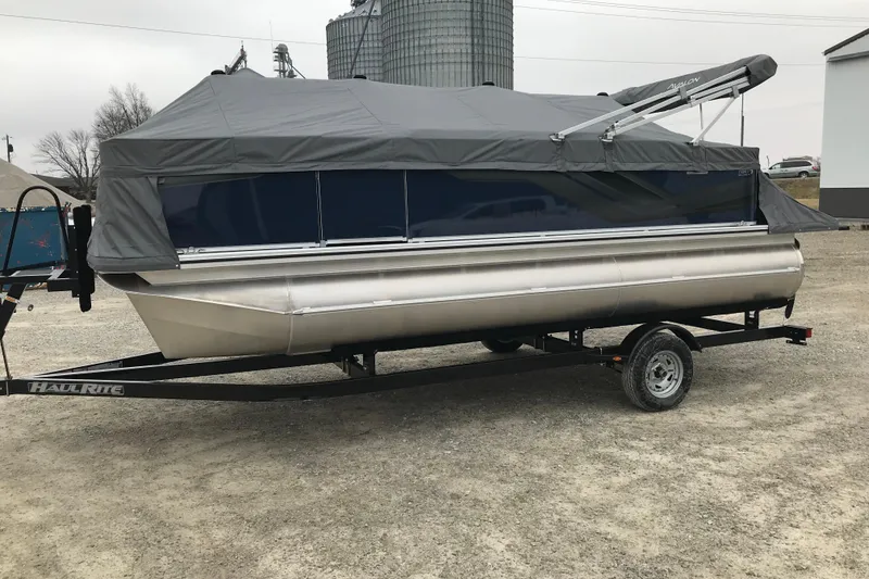Slide: The Image of 2026 Avalon 19 Venture Quad Fish pontoon boat on trailer, covered and ready for transport. - 32